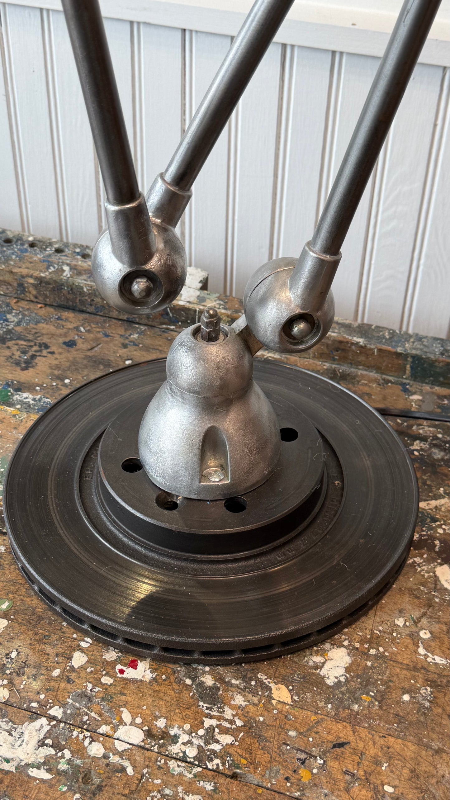 Metallic object with multiple cylindrical components on a textured surface