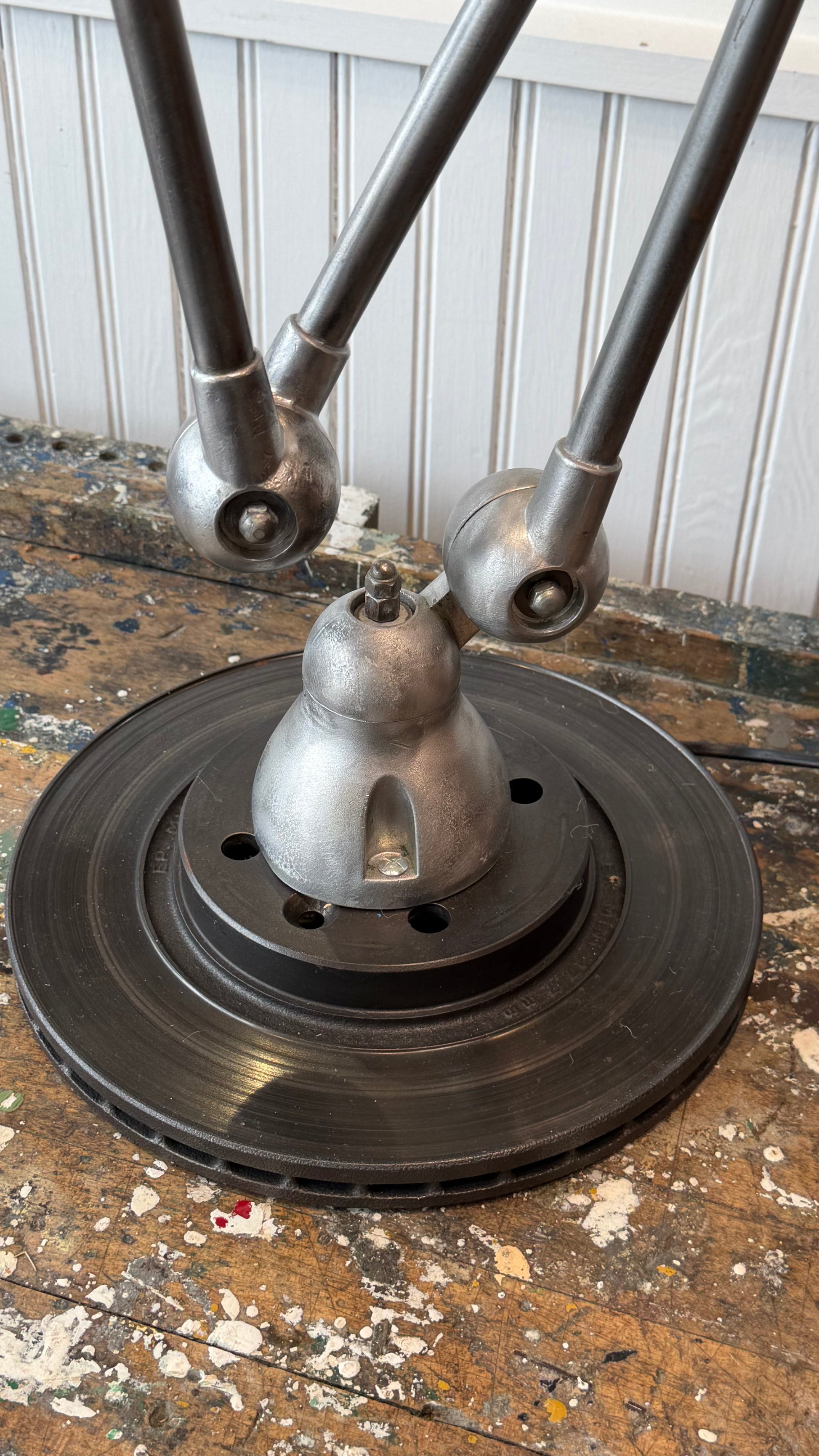 Metallic object with multiple cylindrical components on a textured surface