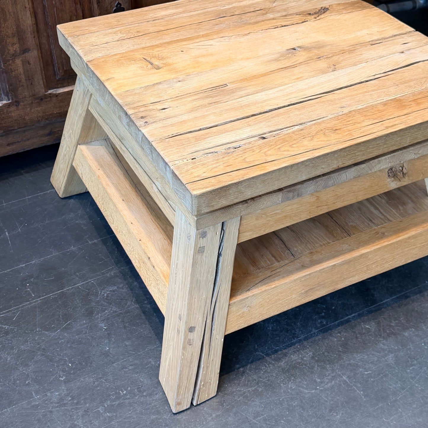 Wooden step stool on a dark floor