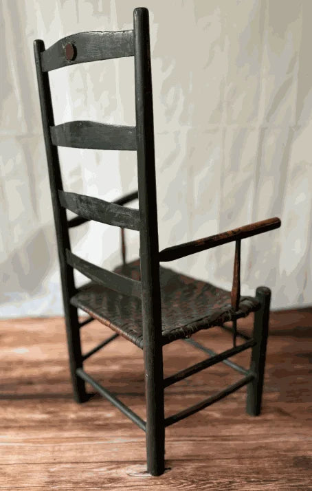 Early 19th Century Early American Ladder Back Arm Chair in Old Black Paint