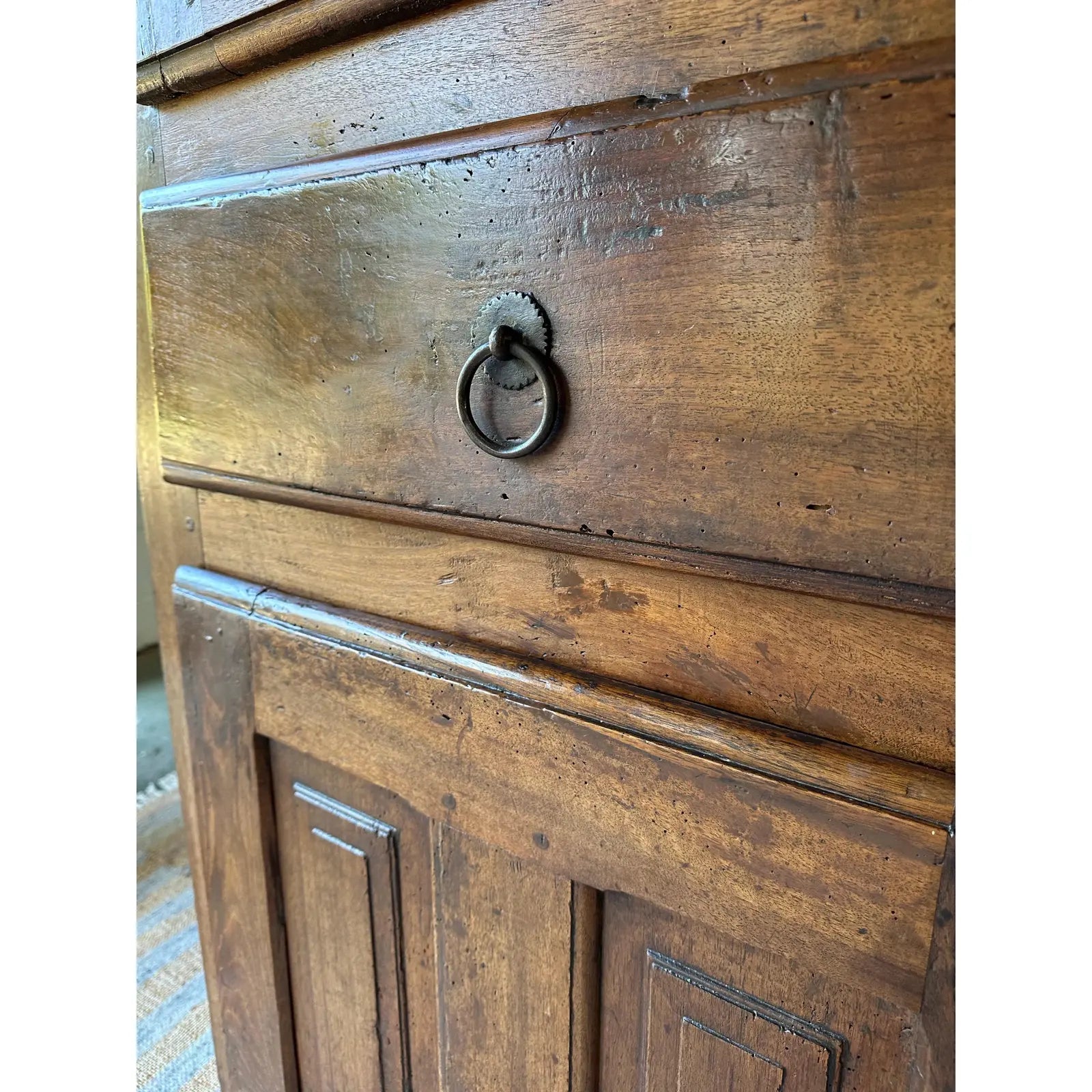 Close-up of a wooden cabinet with a metal handle
