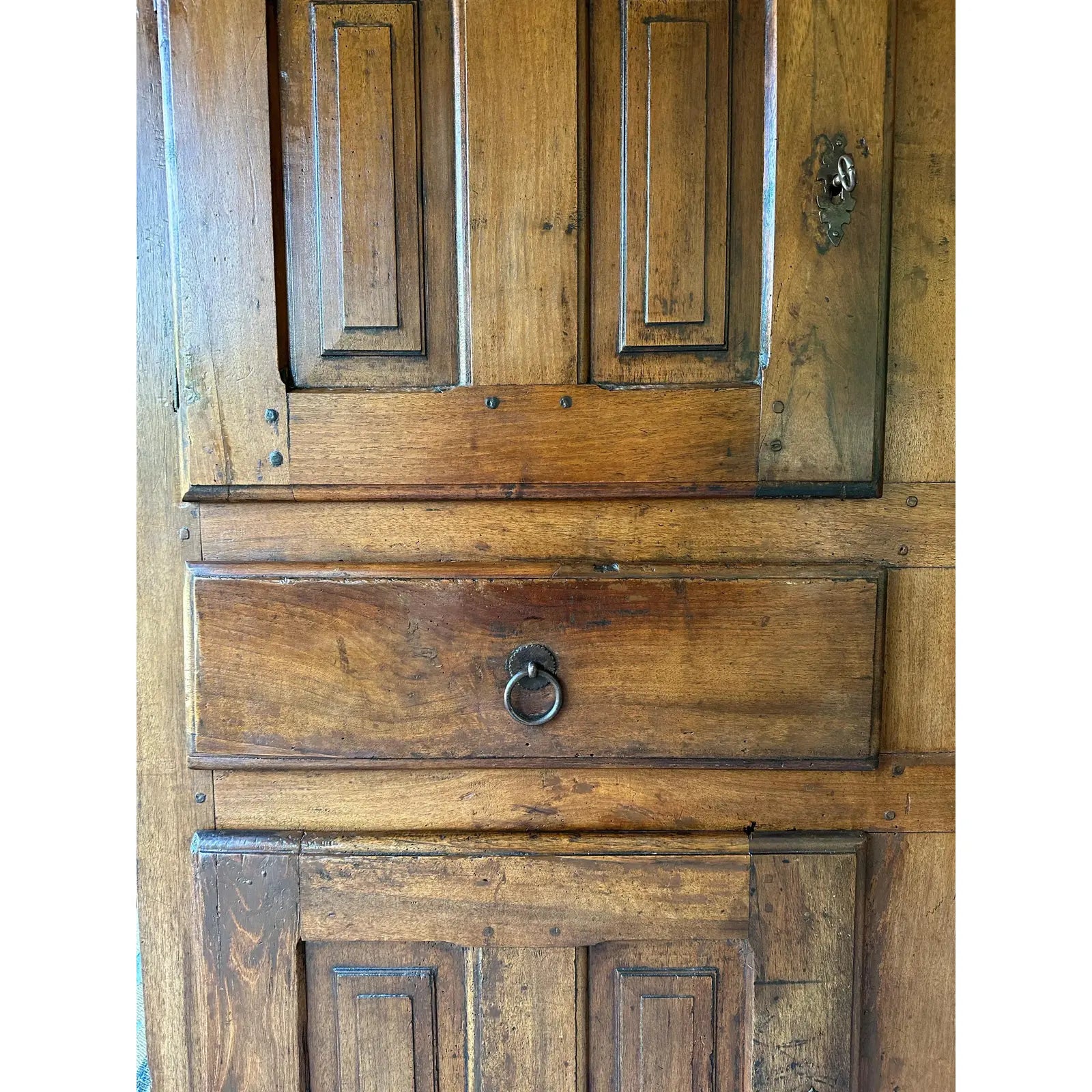 Close-up of a wooden door with a metal handle and lock.